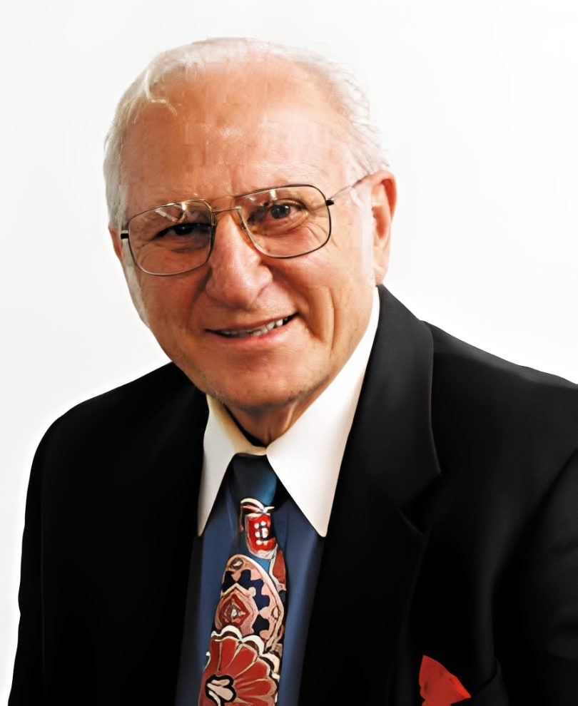 Elderly man smiling in suit